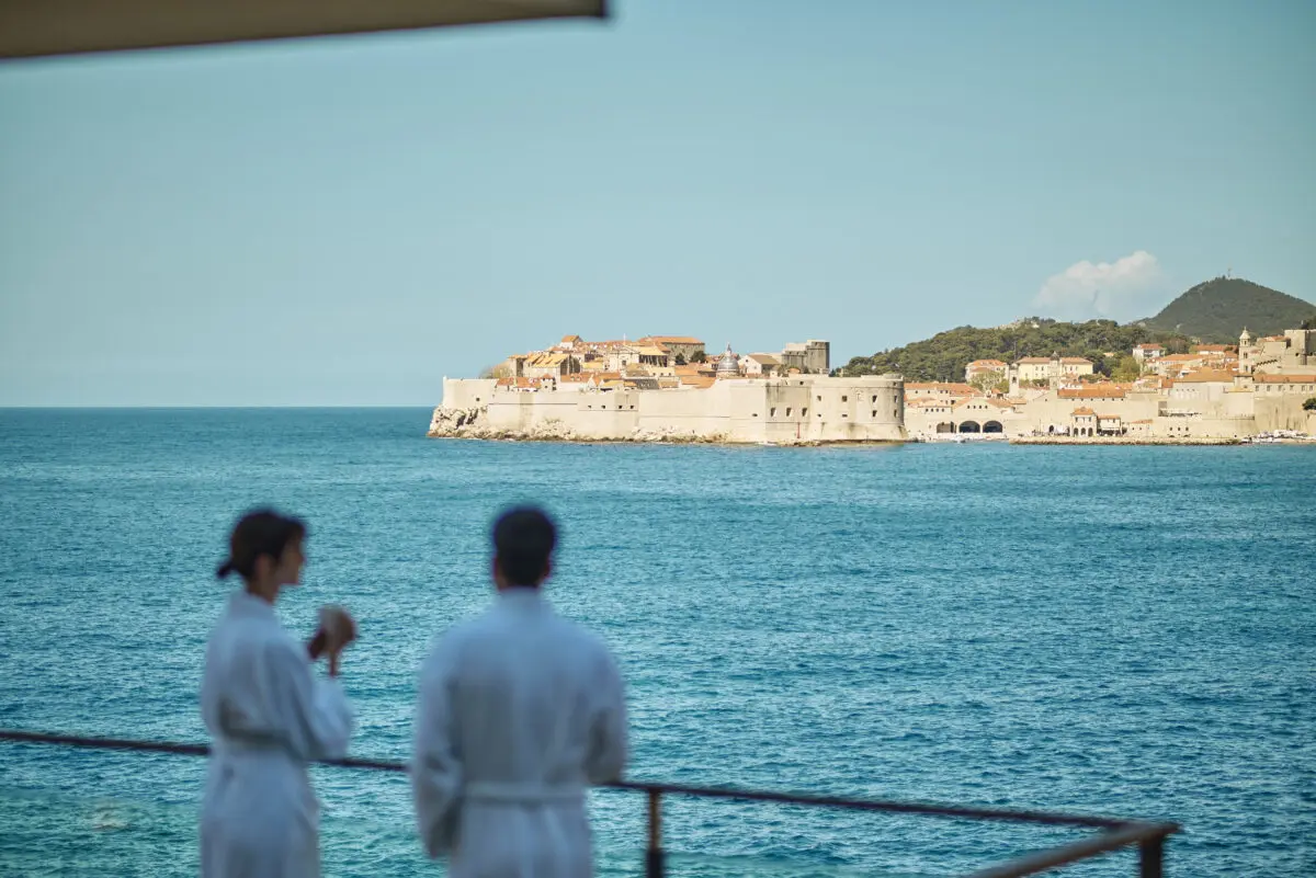 Couple in robes overlooking Dubrovnik, Croatia. Possible destination wedding hotel view.