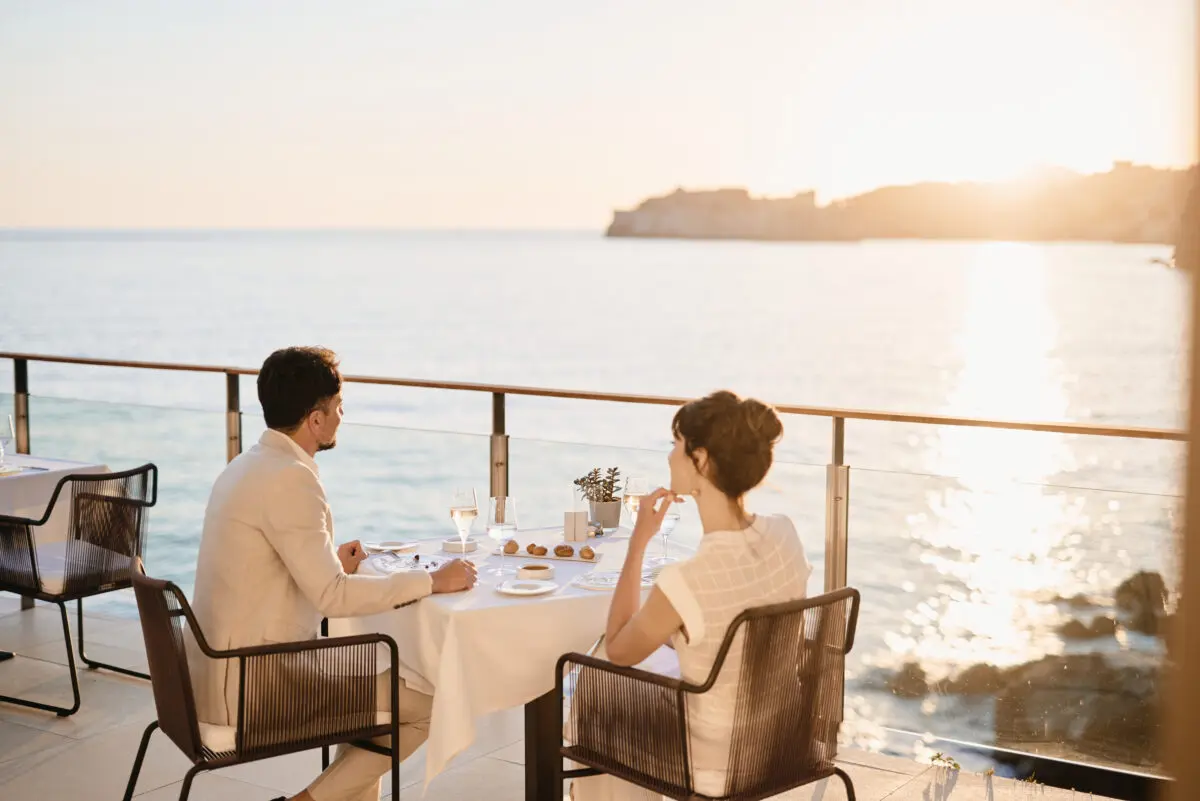 Couple dining at Villa Dubrovnik, a Croatia destination wedding hotel, with a stunning ocean view.