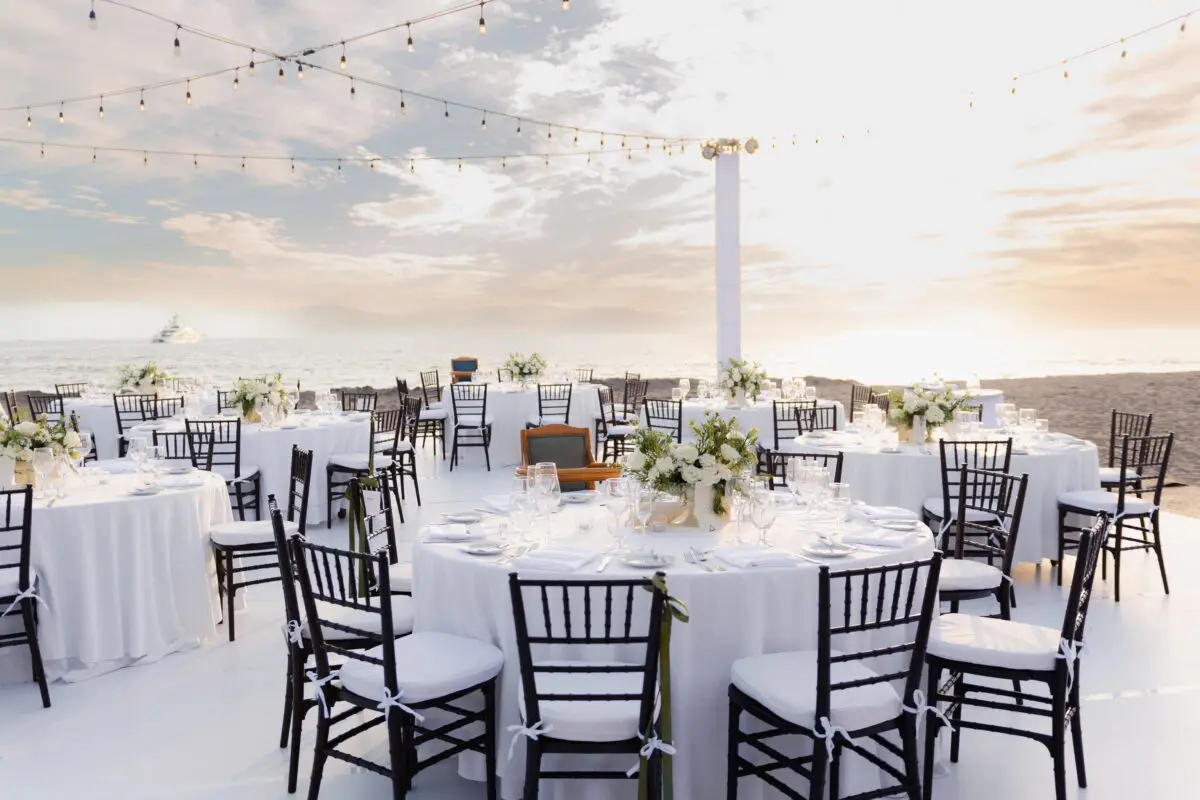 Beachfront wedding reception at Velas Vallarta in Puerto Vallarta with elegant table settings.