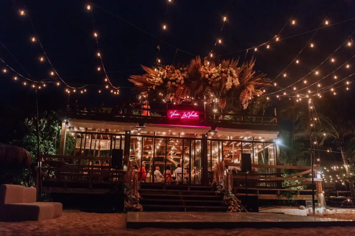 Jashita Hotel Tulum wedding venue at night, with string lights and floral arch.
