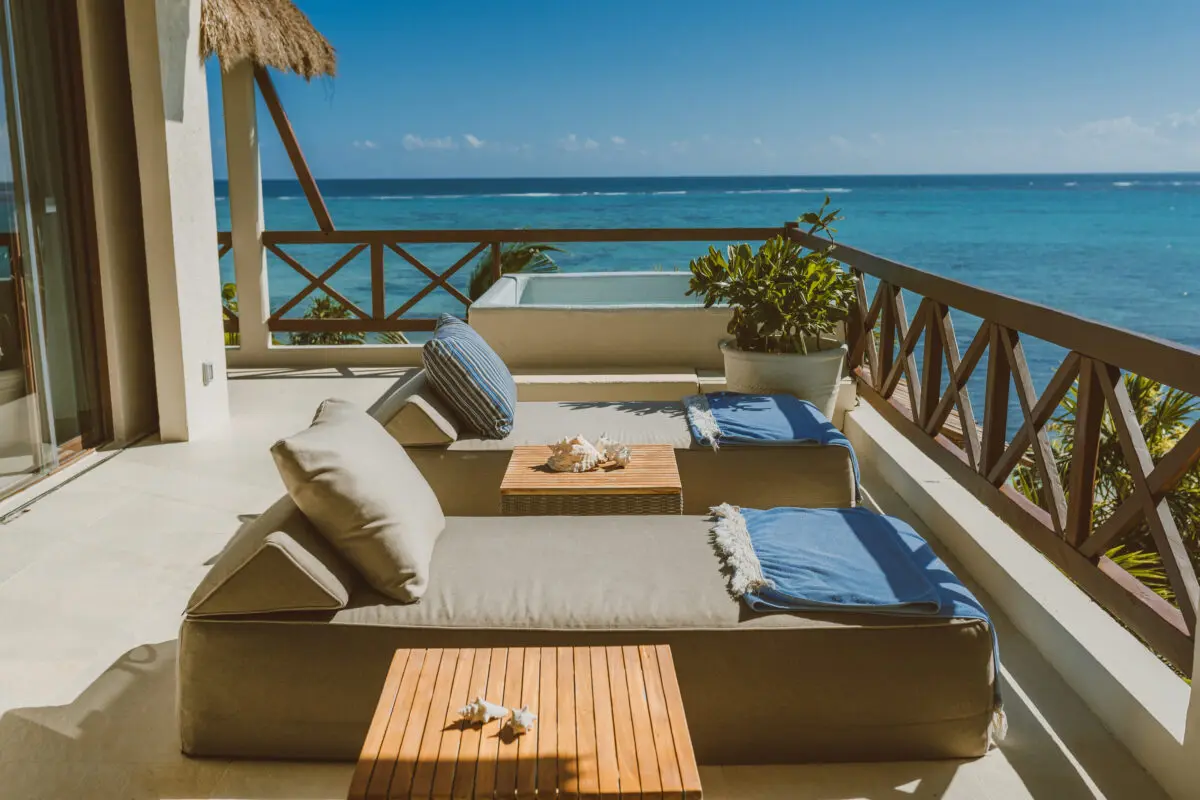 Luxury lounge chairs on a balcony overlooking the ocean at Jashita Hotel Tulum, a Tulum wedding venue.