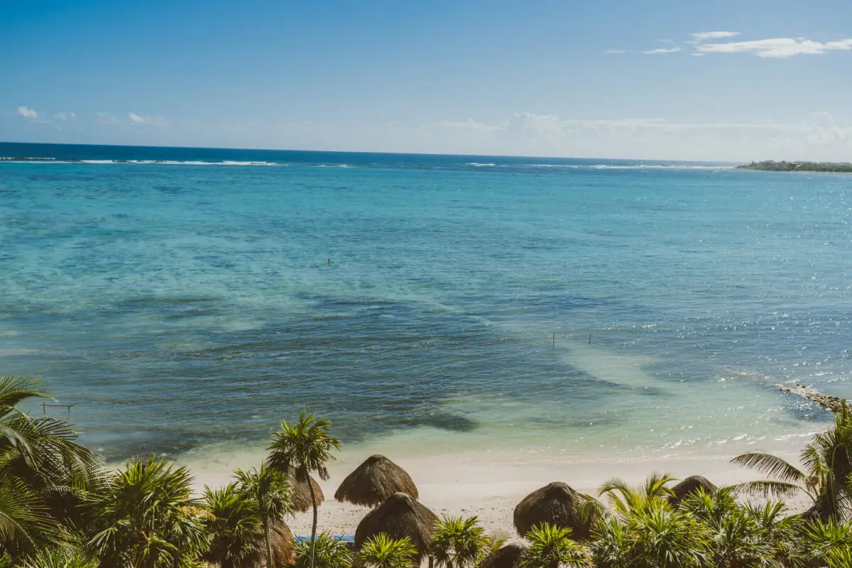 Beach view from Jashita Hotel Tulum, a beautiful Tulum wedding venue with turquoise water and palm trees.