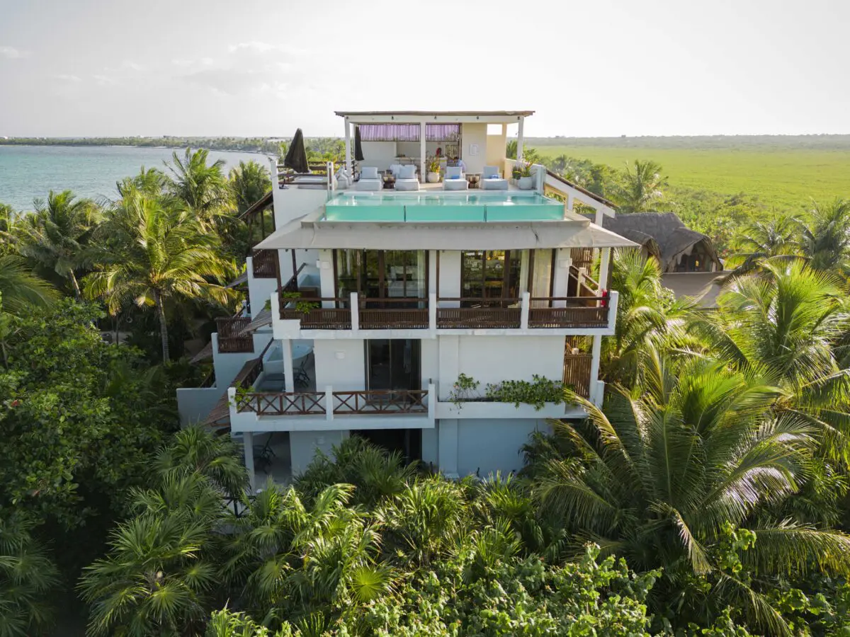 Jashita Hotel Tulum aerial view with rooftop pool surrounded by lush greenery and ocean backdrop. Ideal Tulum wedding venue.