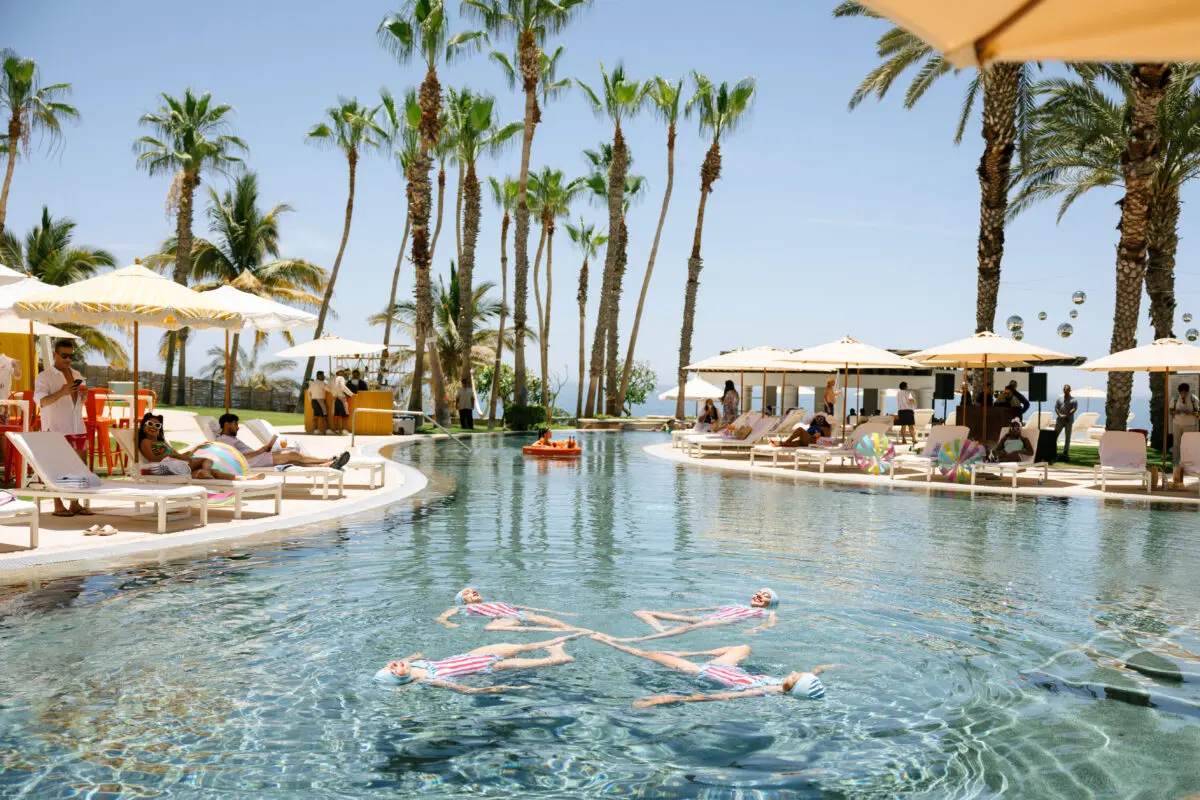 Los Cabos destination wedding at Hilton: synchronized swimmers in pool.