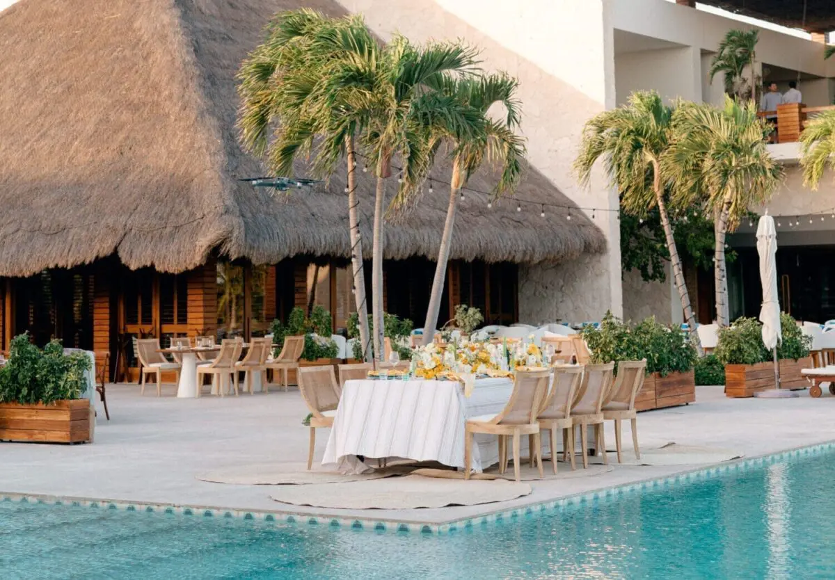 Luxury wedding reception table at a Mexican resort, overlooking a pool.