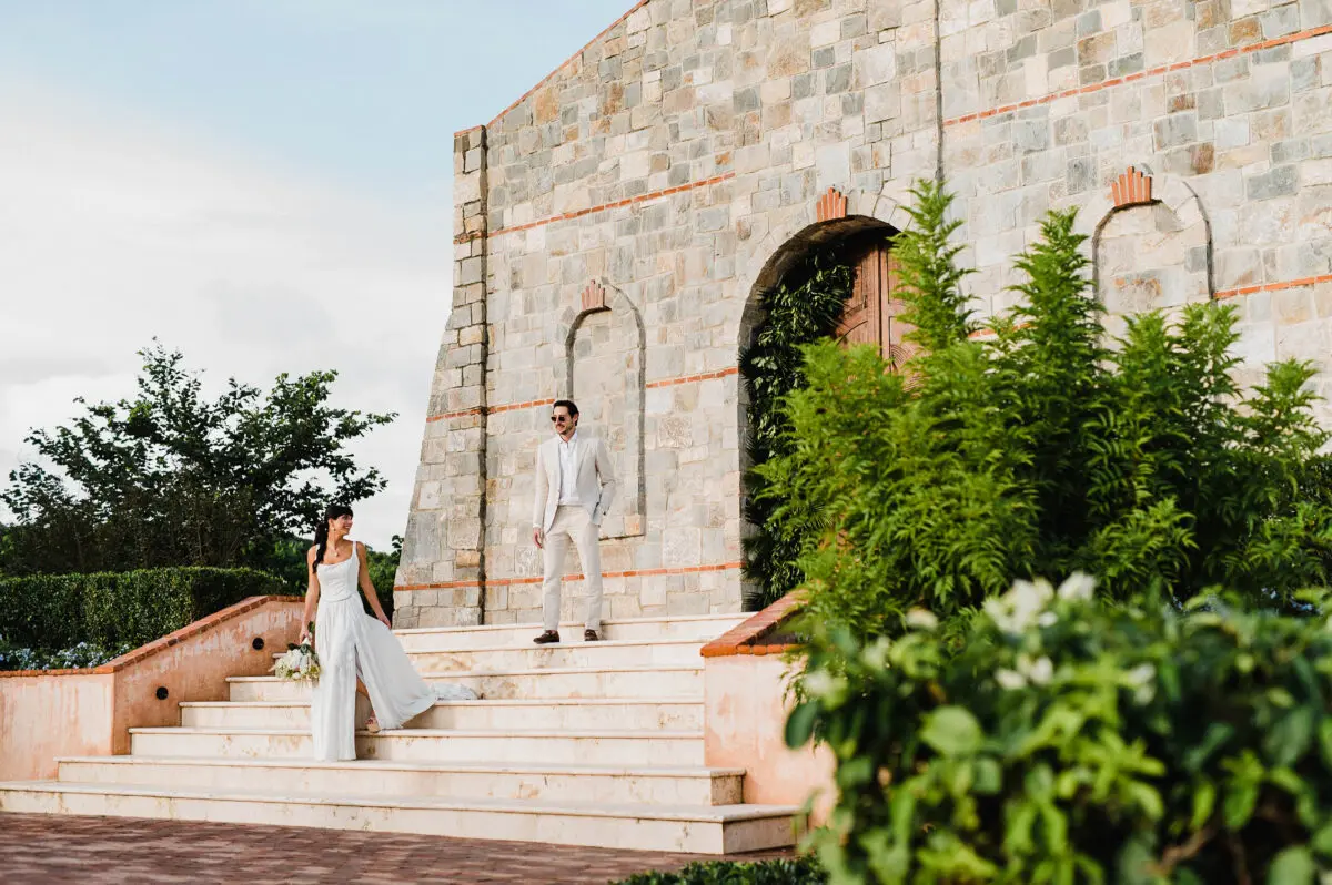 Bride and groom on stairs at Rancho Santana wedding venue.