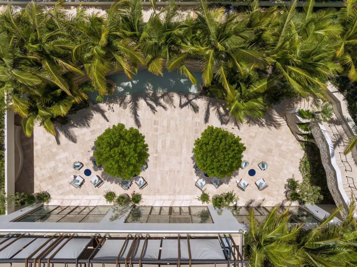 Aerial view of The St. Regis Cap Cana Resort courtyard with palm trees and seating.