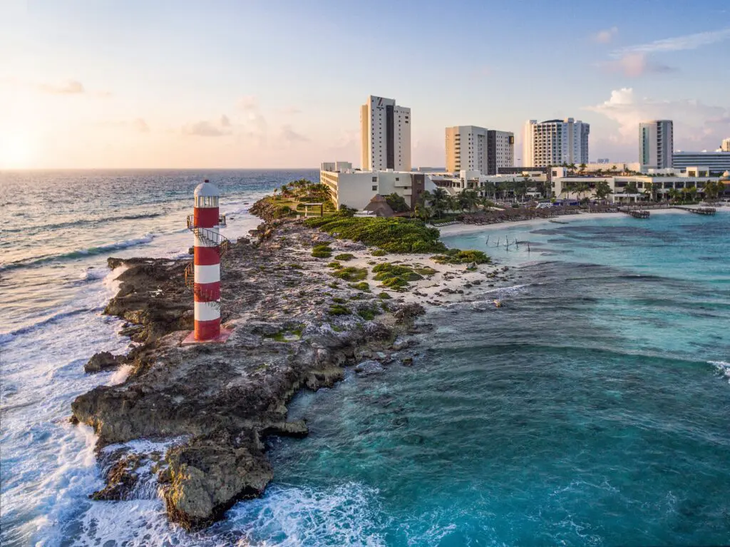 Cancun lighthouse on rocky shore near Hyatt Ziva, a luxury wedding venue in Cancun with ocean views.
