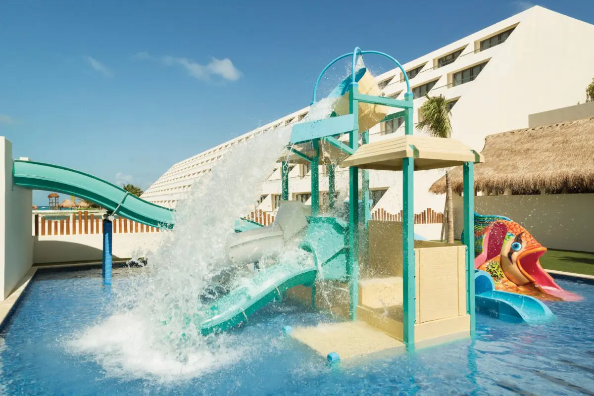 Hyatt Ziva Cancun water park with slides and playful fish design.