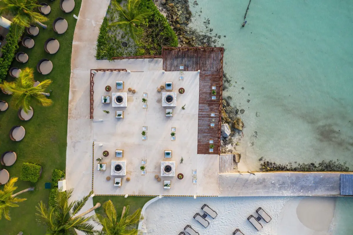 Aerial view of the Hyatt Ziva Cancún, a luxury wedding venue with beachfront seating and turquoise water.