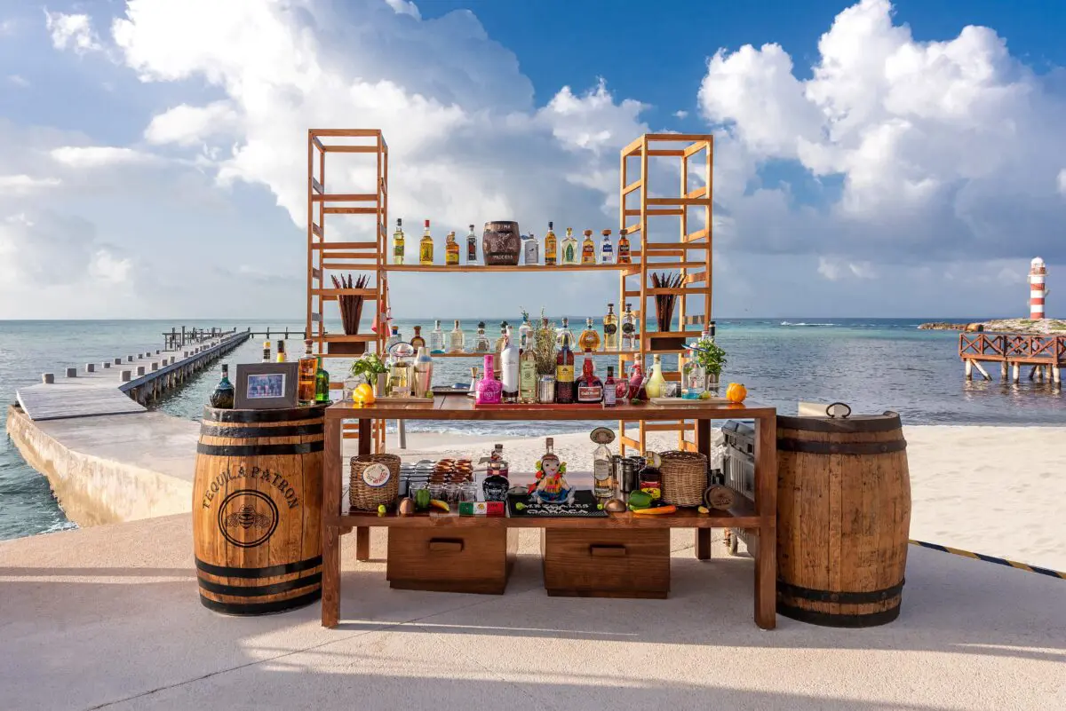 Luxury wedding venue in Cancun: Beachfront bar with liquor and lighthouse view.