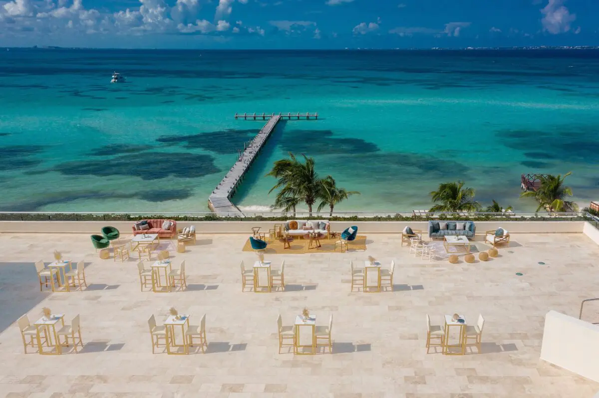Hyatt Ziva Cancun luxury wedding venue with beachfront tables, lounge areas, and a pier over turquoise water.