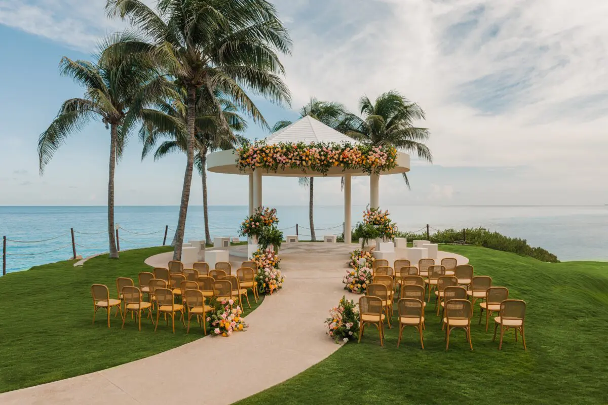 Luxury wedding venue in Cancun: Oceanfront ceremony with floral gazebo.