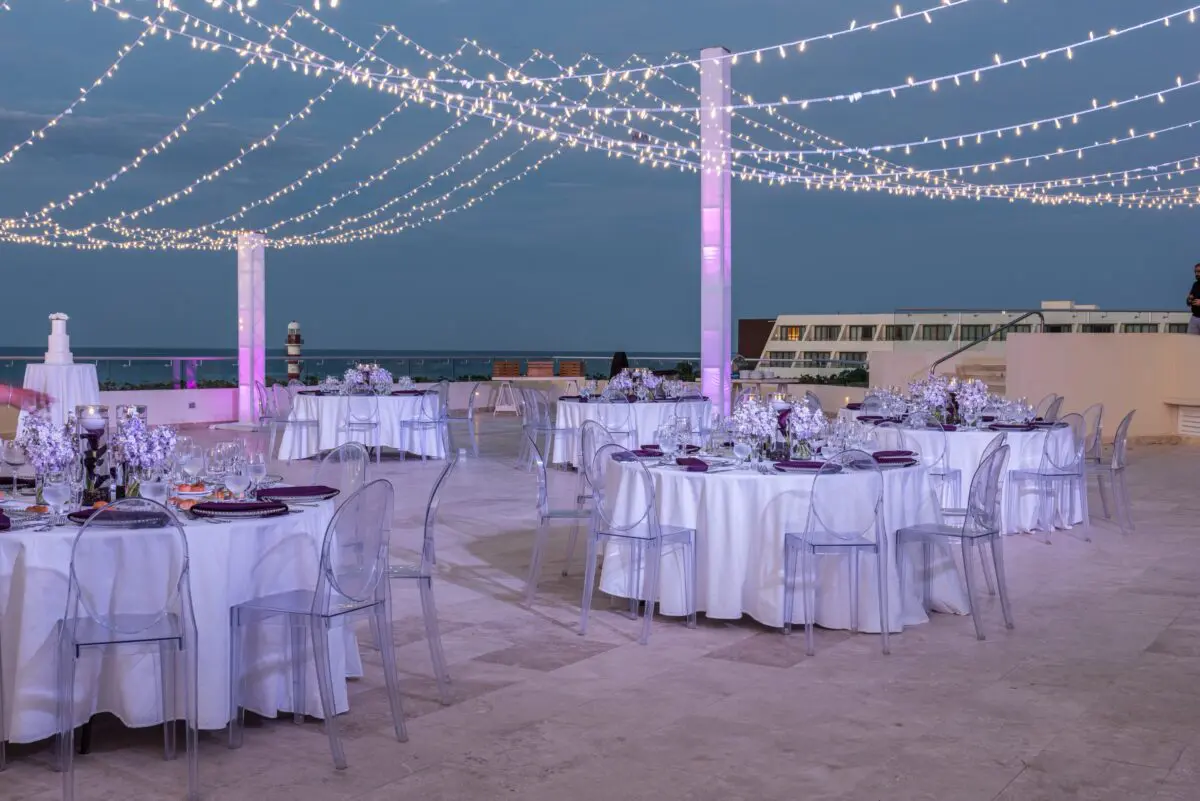 Wedding reception at Hyatt Ziva Cancún, a luxury wedding venue in Cancun, with string lights and round tables.