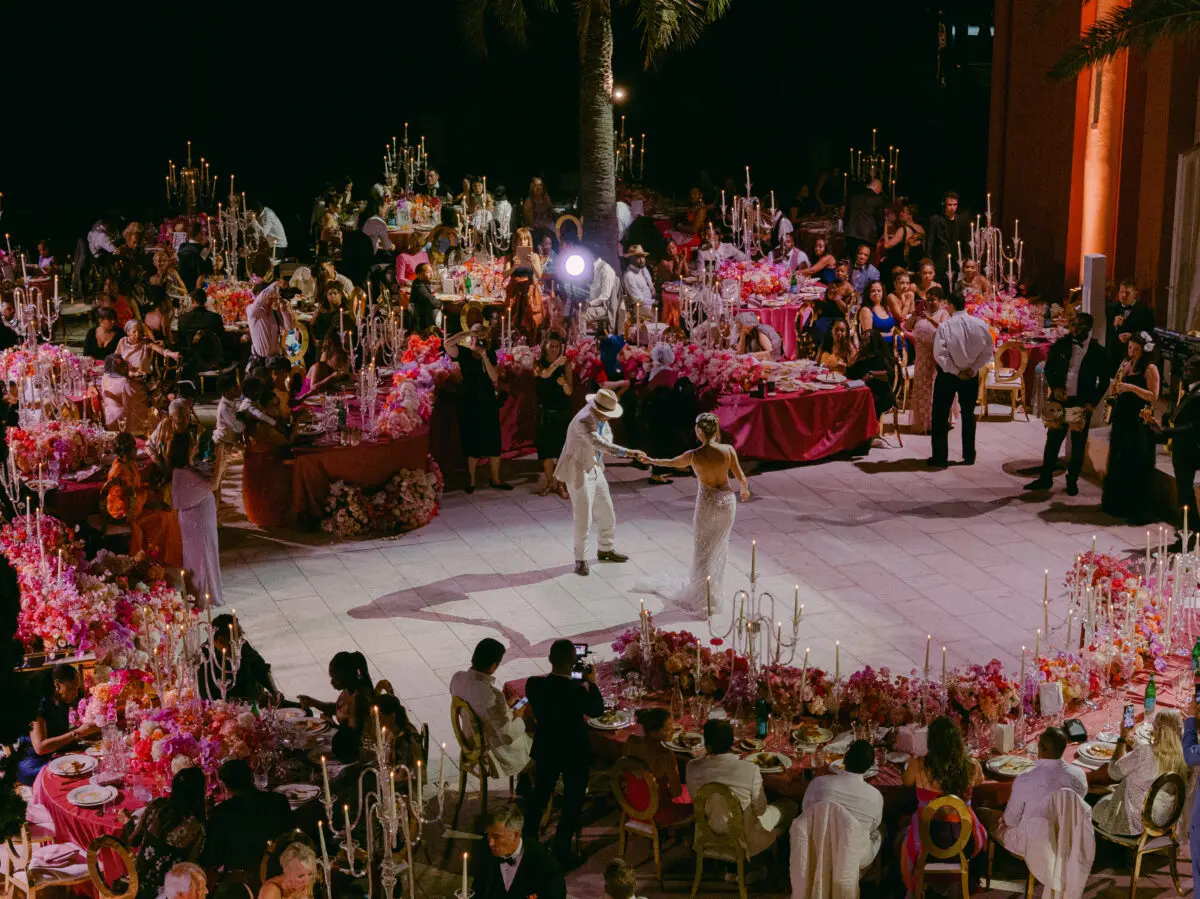 Luxury wedding in Saint-Tropez: Couple dancing at outdoor reception with floral centerpieces and candelabras.