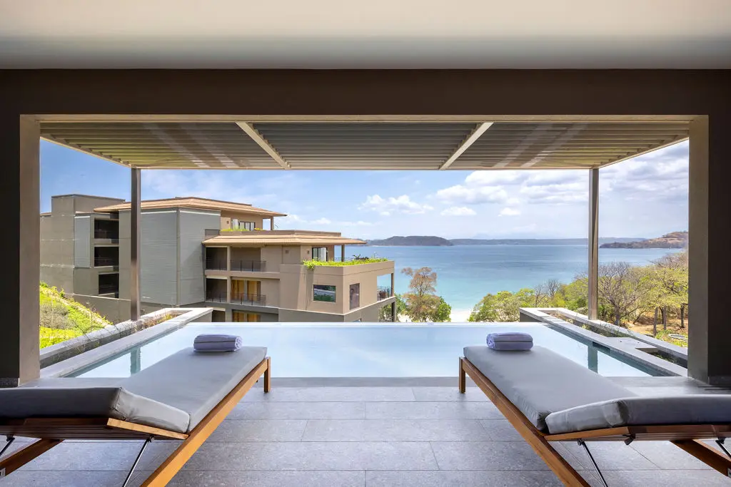 Waldorf Astoria Costa Rica ocean view with infinity pool and lounge chairs.