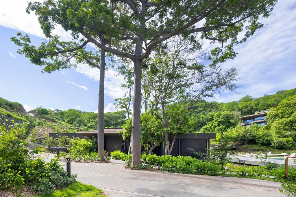 Waldorf Astoria Costa Rica: Modern architecture blends with lush tropical landscape and a glimpse of a pool.