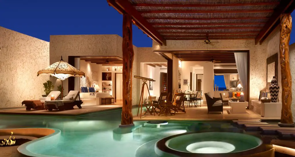 Luxury hotel room design featuring a private pool, open-air living spaces, and elegant interior decor.