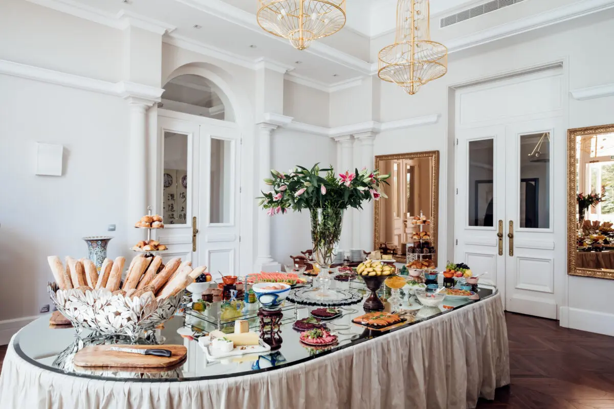 Buffet table at COMO Le Beauvallon, Saint-Tropez, with bread, fruit, and pastries.