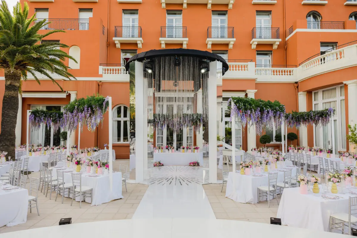 Luxury wedding setup at COMO Le Beauvallon in Saint-Tropez. Tables and floral decorations under a modern canopy.