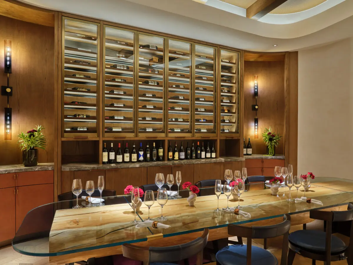 Wine room at The St. Regis Cap Cana Resort, an exclusive wedding resort in Punta Cana, with a long table set for a tasting.