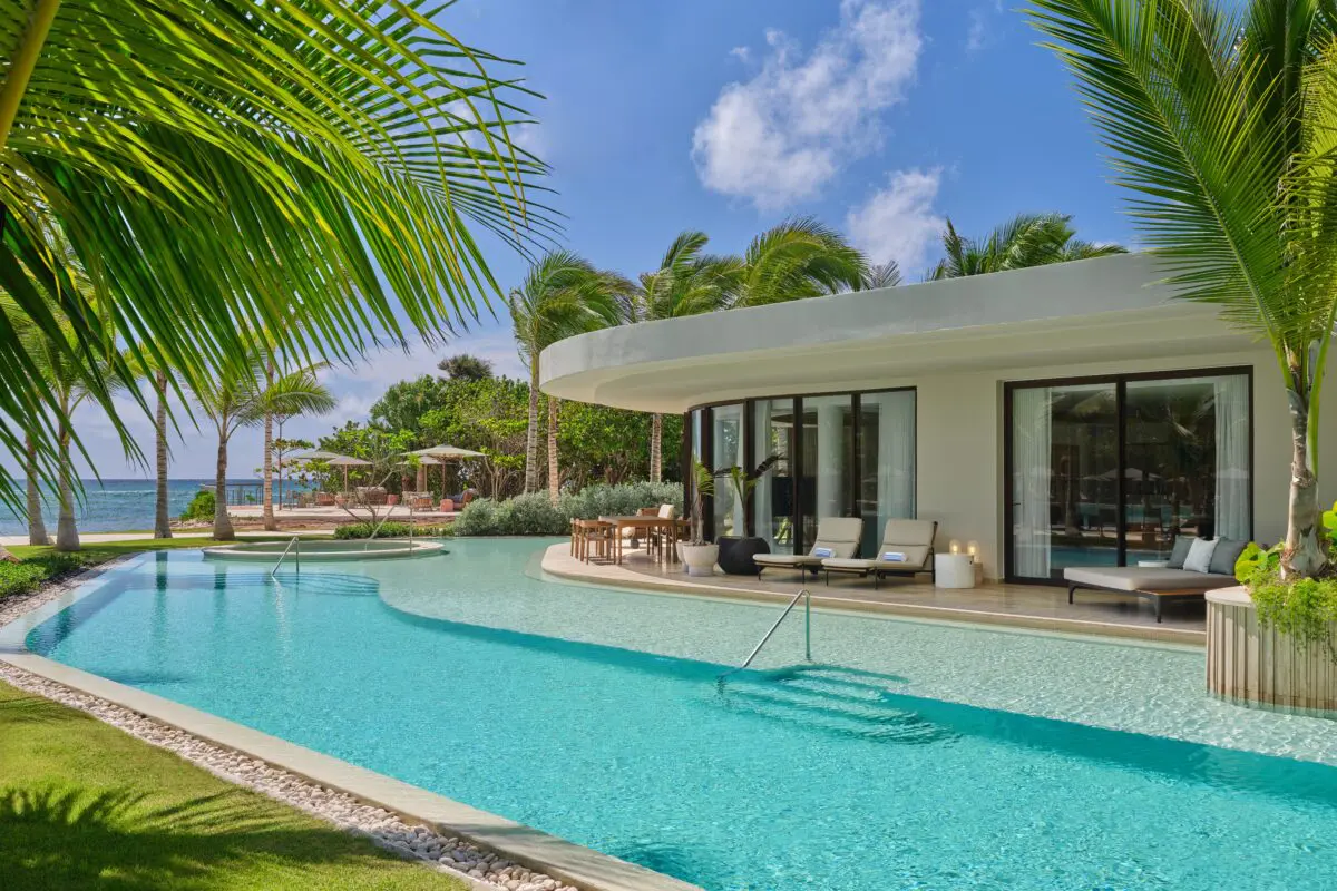 Luxury pool at The St. Regis Cap Cana Resort, an exclusive wedding resort in Punta Cana, with palm trees and ocean view.