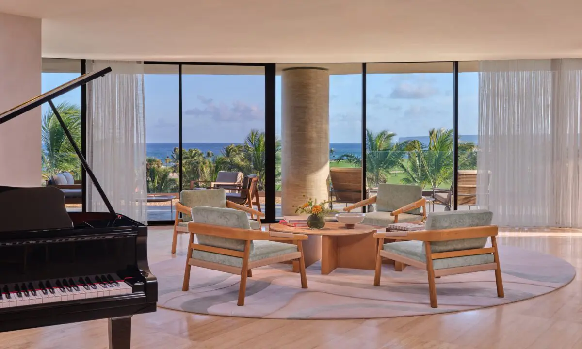 Elegant seating area with a piano at The St. Regis Cap Cana Resort, a potential exclusive wedding resort in Punta Cana.