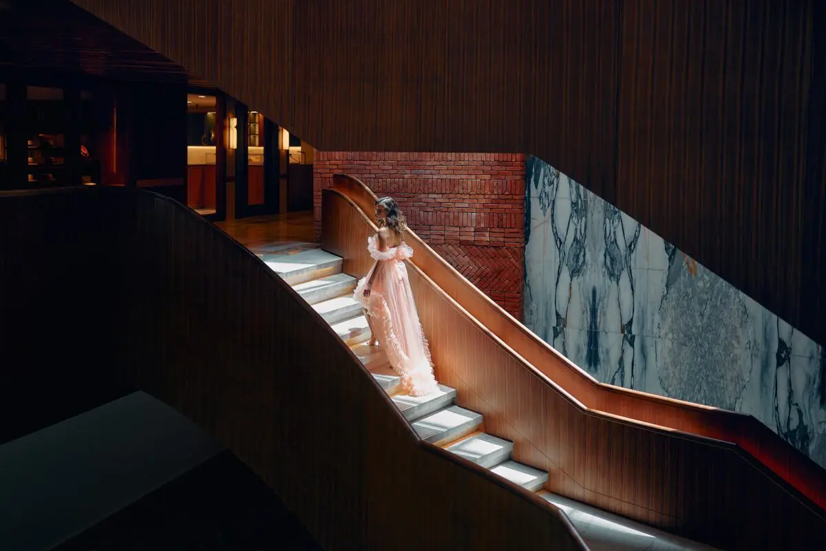 Woman in gown on stairs at The St. Regis Cap Cana Resort, a stunning venue for exclusive weddings in Punta Cana.