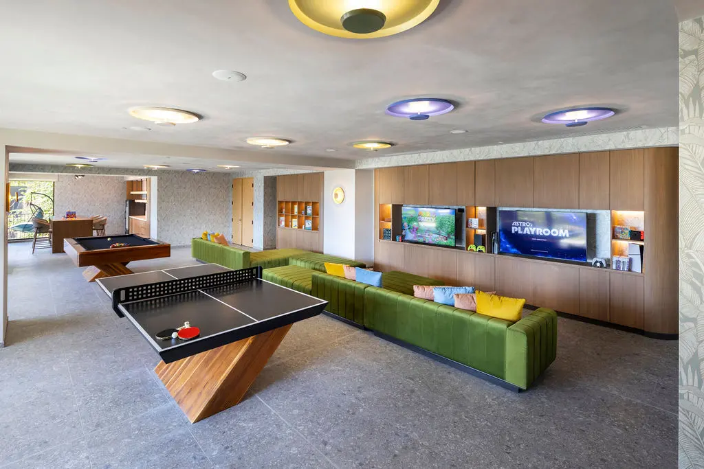Game room at Waldorf Astoria Costa Rica with pool table, ping pong, and lounge seating.