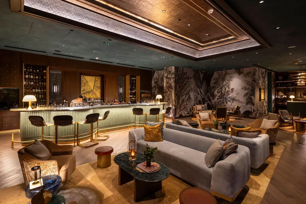 Luxurious bar and lounge at the Waldorf Astoria Costa Rica, featuring stylish seating and a fully stocked bar.