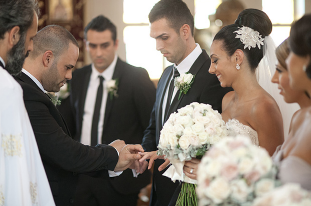 Greek wedding couple at the ring exchange of the ceremony