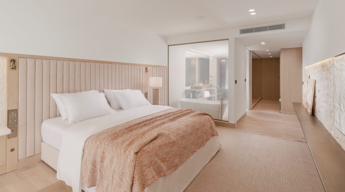 Villa Dubrovnik hotel room featuring a plush bed, modern bathroom, and neutral decor. Croatia Destination Wedding Hotel.