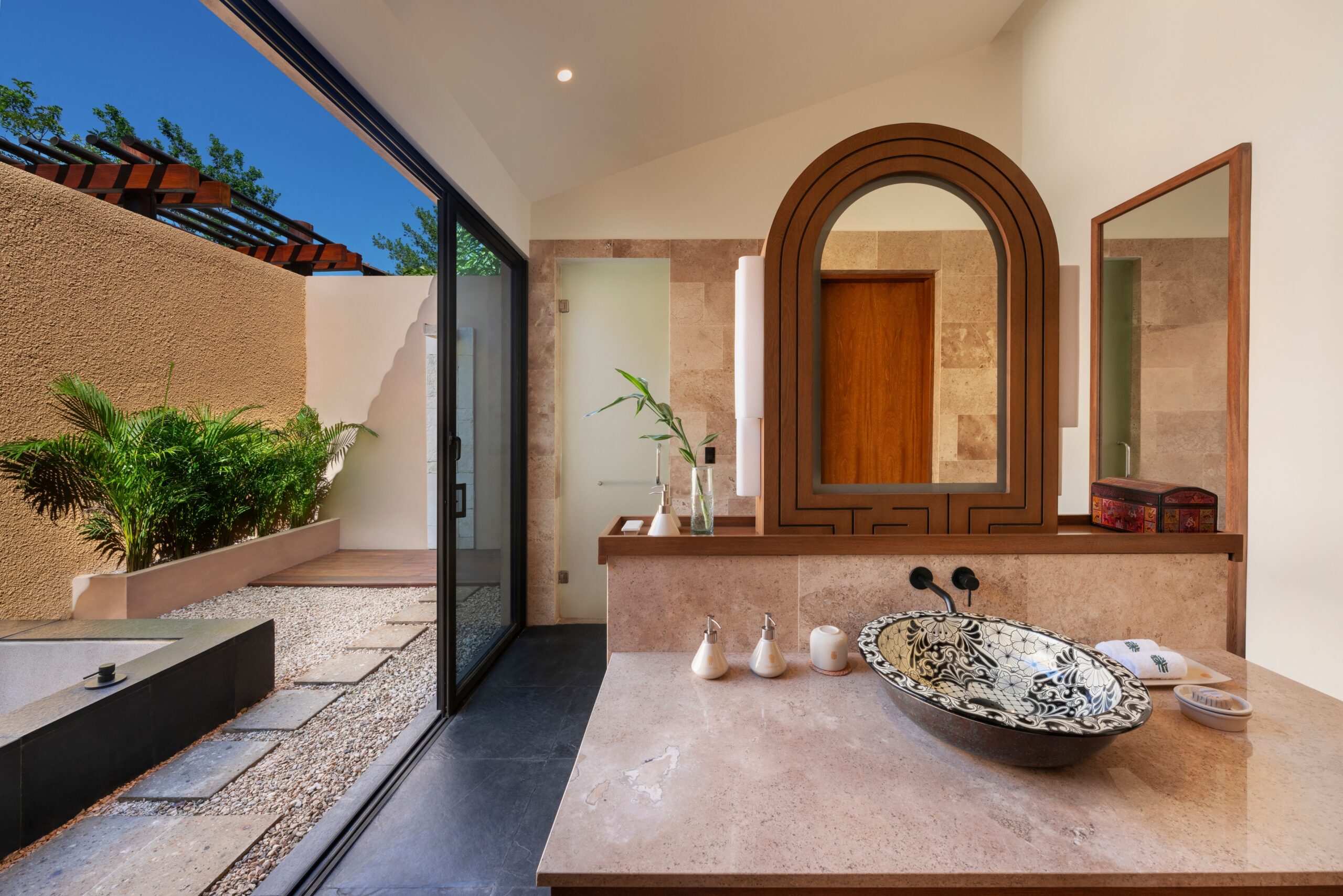 Luxurious bathroom at Banyan Tree Mayakoba, with open-air patio and unique sink.