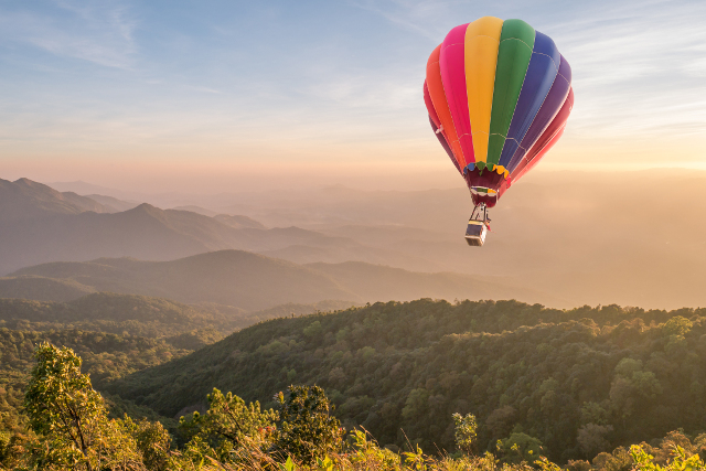 colorful hot air balloon over the Tuscan landscape