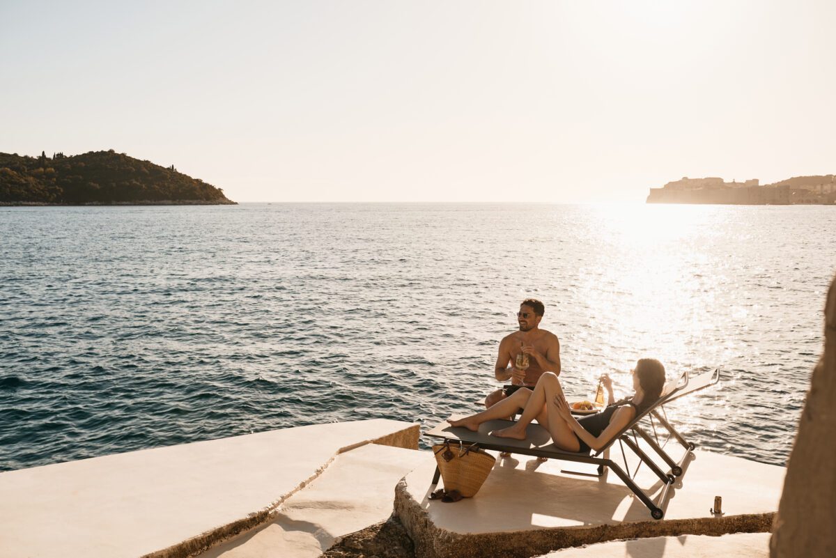 Couple toasting with wine at Villa Dubrovnik, a Croatia destination wedding hotel, overlooking the Adriatic Sea.