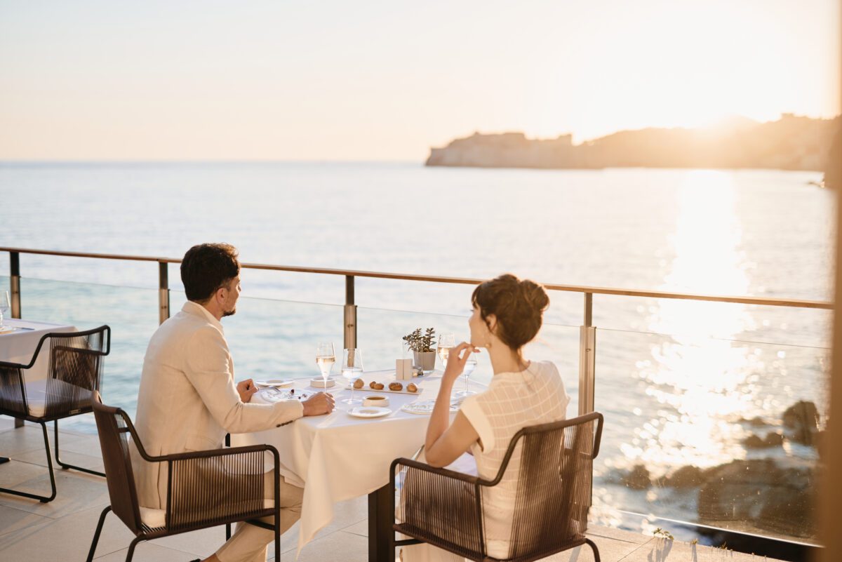Couple dining at Villa Dubrovnik, a Croatia destination wedding hotel, with a stunning ocean view.