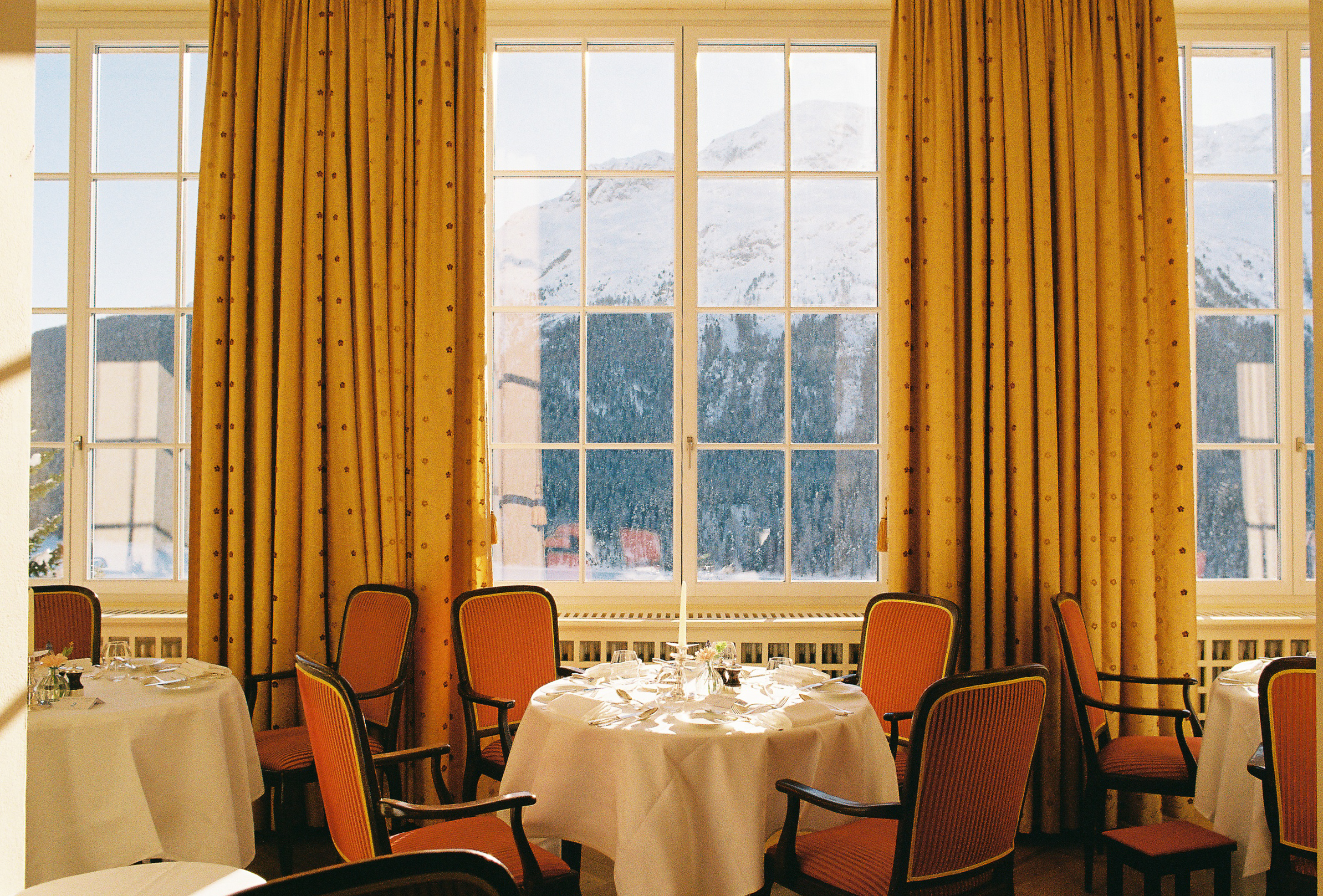 Elegant dining room at Kulm Hotel St. Moritz with mountain view, perfect for a Switzerland Wedding.