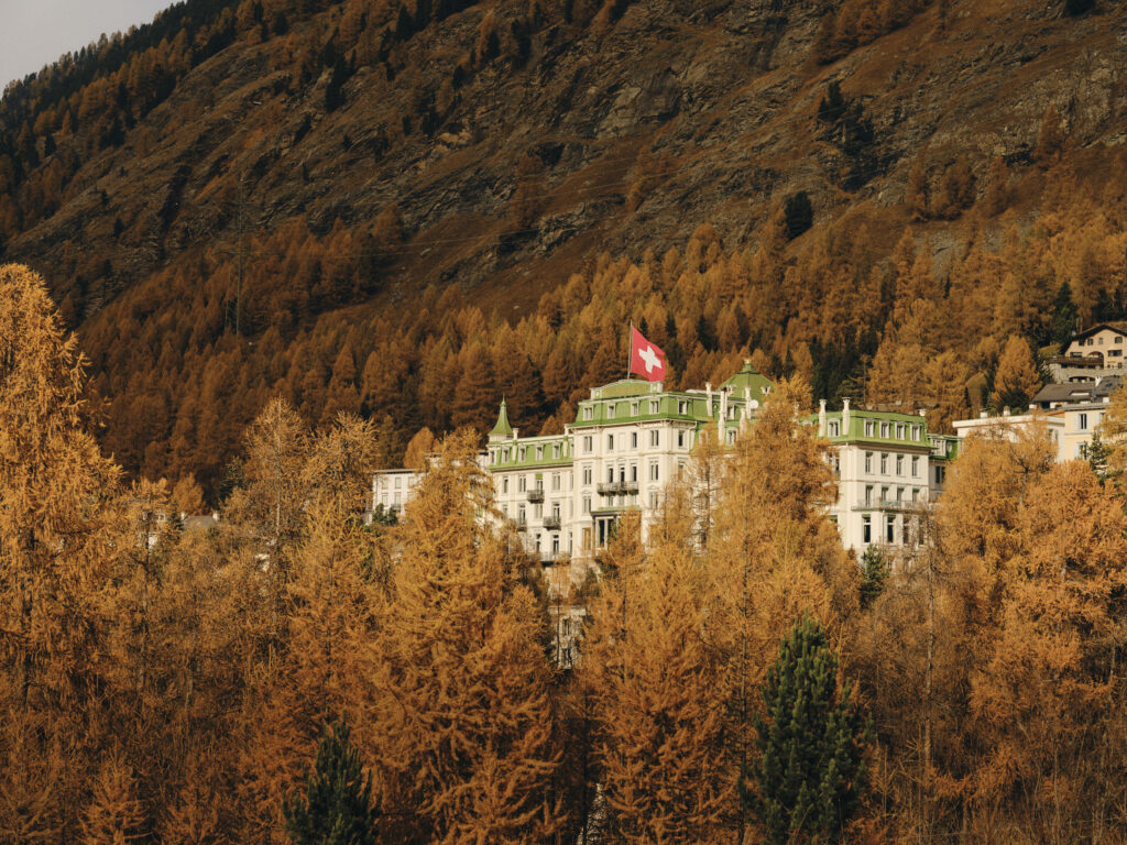 Grand Hotel Kronenhof in the Swiss Alps, surrounded by autumn trees.