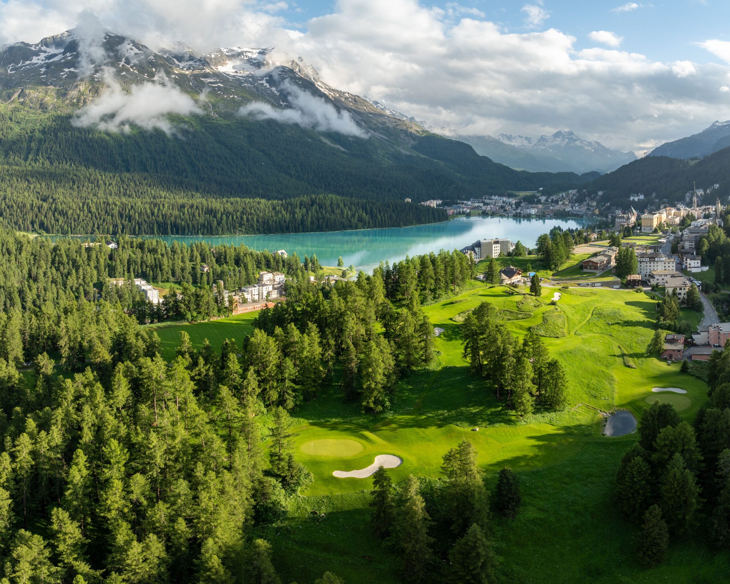 Kulm Hotel St. Moritz view with golf course, lake, mountains. Ideal Switzerland wedding venue.