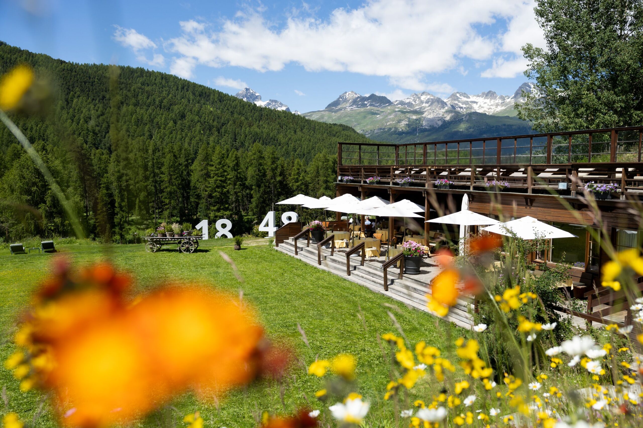 Grand Hotel Kronenhof terrace with Swiss Alps view.