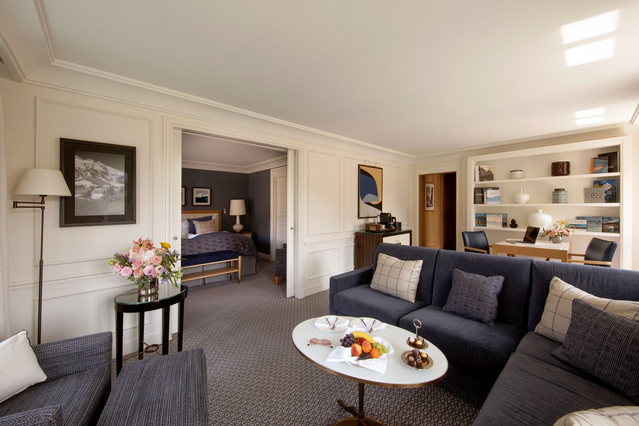 Hotel suite at Grand Hotel Kronenhof with living area, bedroom, and fruit platter.