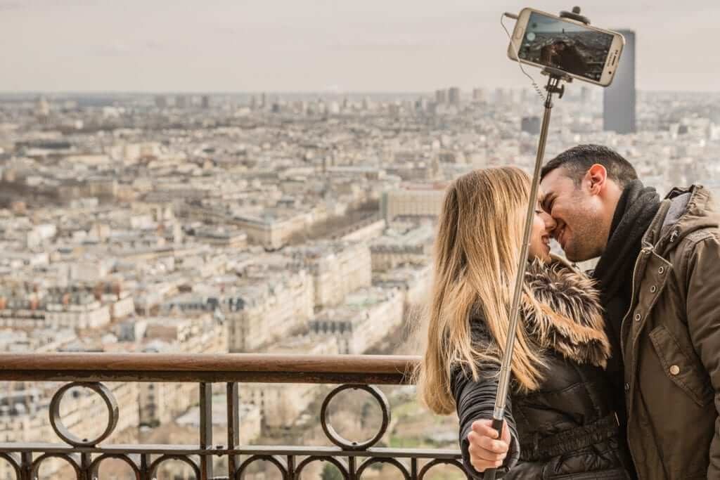 couple taking honeymoon picture for instagram