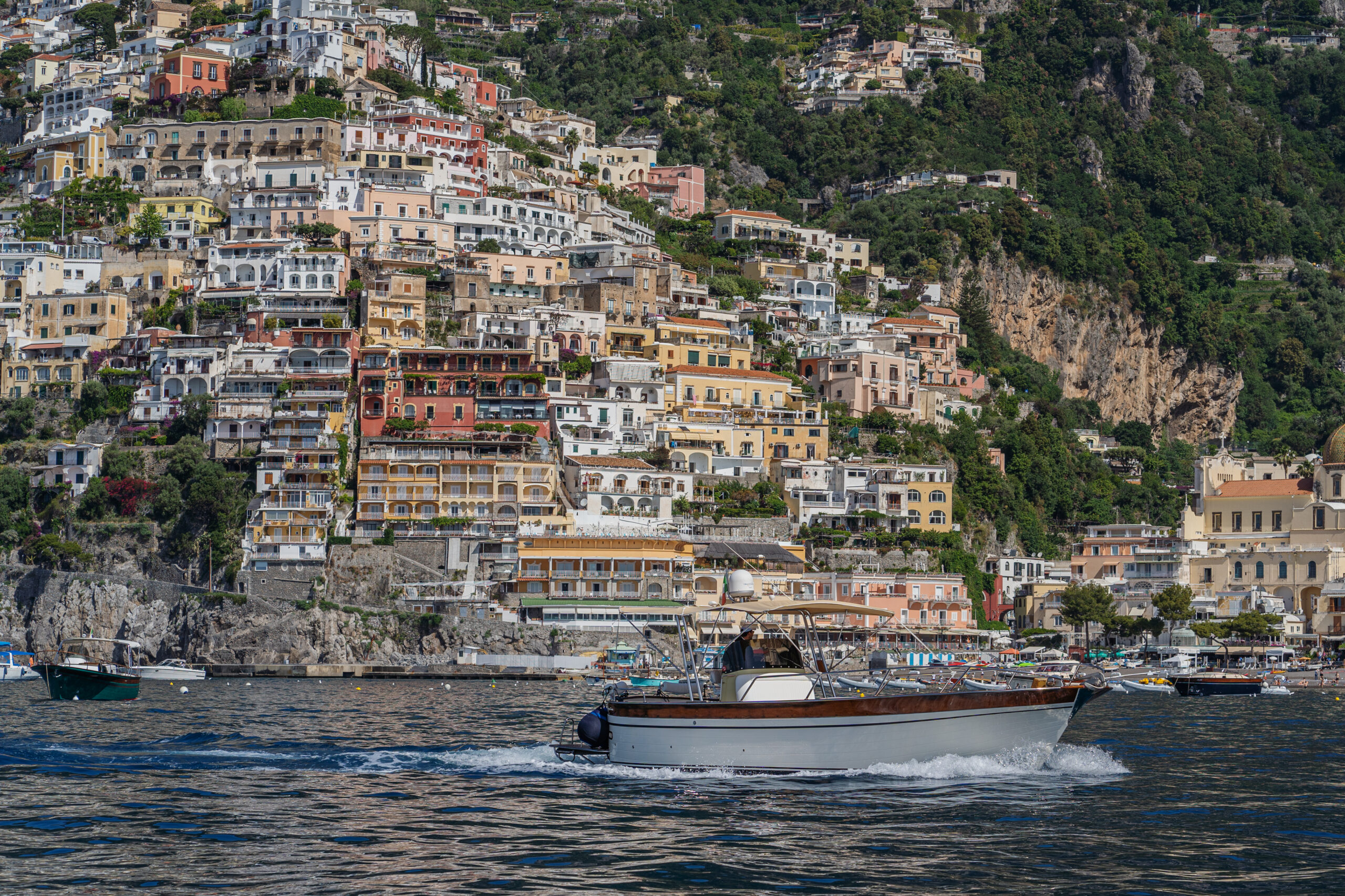 Boat cruising near Positano on the Amalfi Coast, a beautiful location for a Casa Angelina wedding.