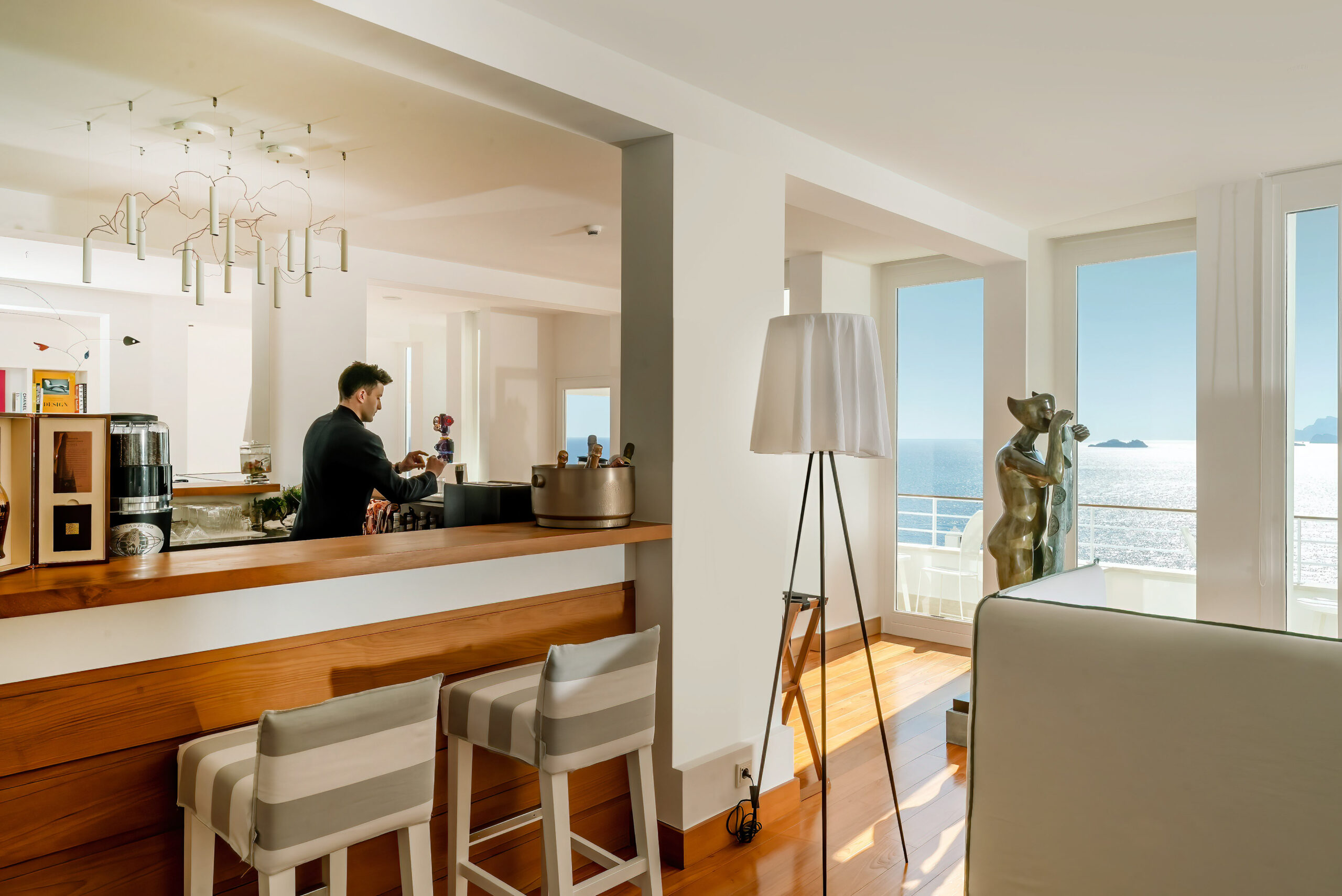 Casa Angelina interior with bar, stools, and ocean view. Ideal for an Amalfi Coast wedding.