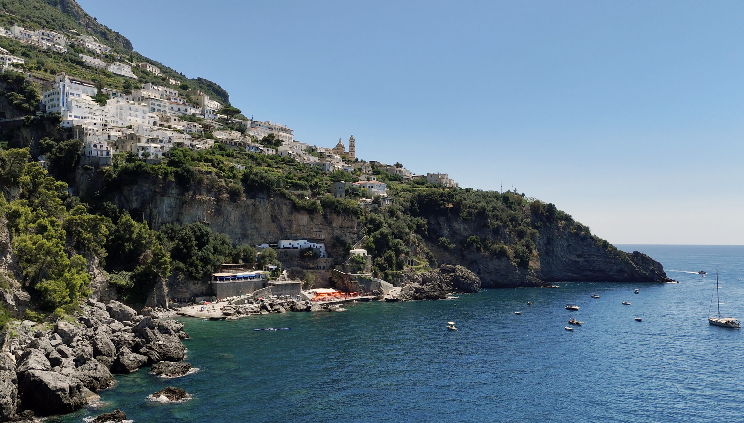 Amalfi Coast view with white buildings cascading down the cliffside, perfect for a Casa Angelina wedding.