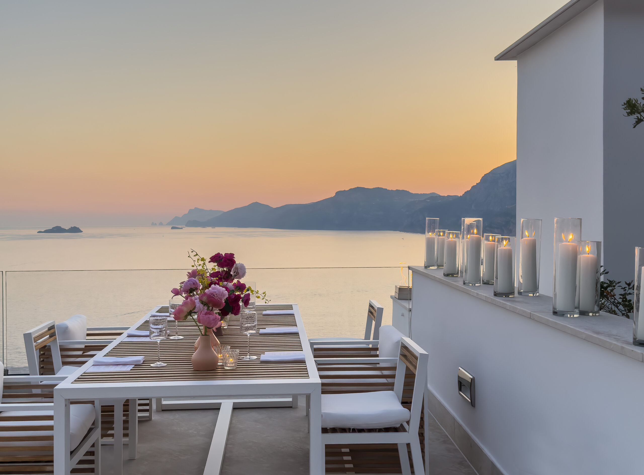 Amalfi Coast Wedding dinner setup overlooking the sea at Casa Angelina hotel at sunset.