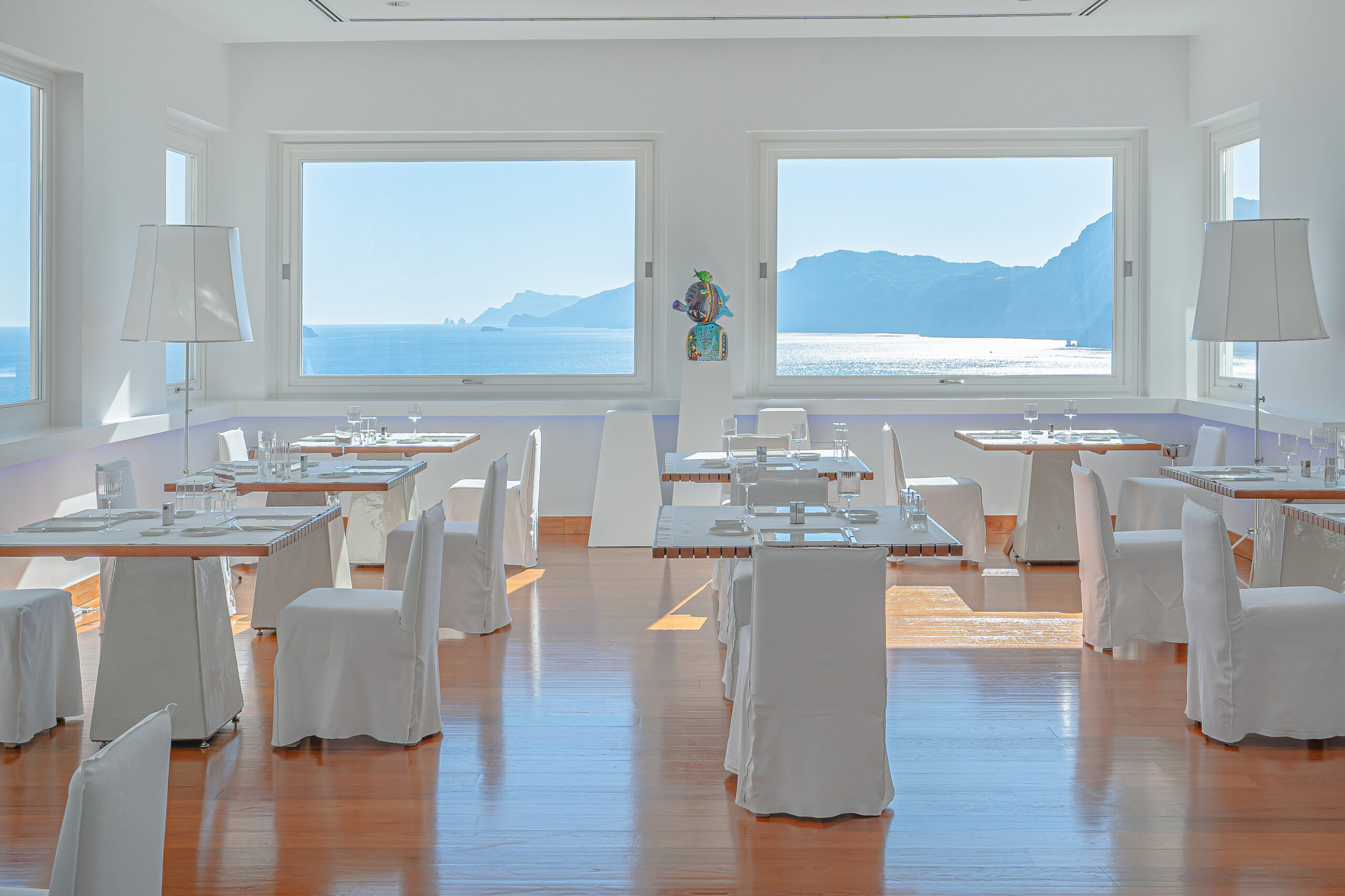 Casa Angelina restaurant with Amalfi Coast view and white decor.