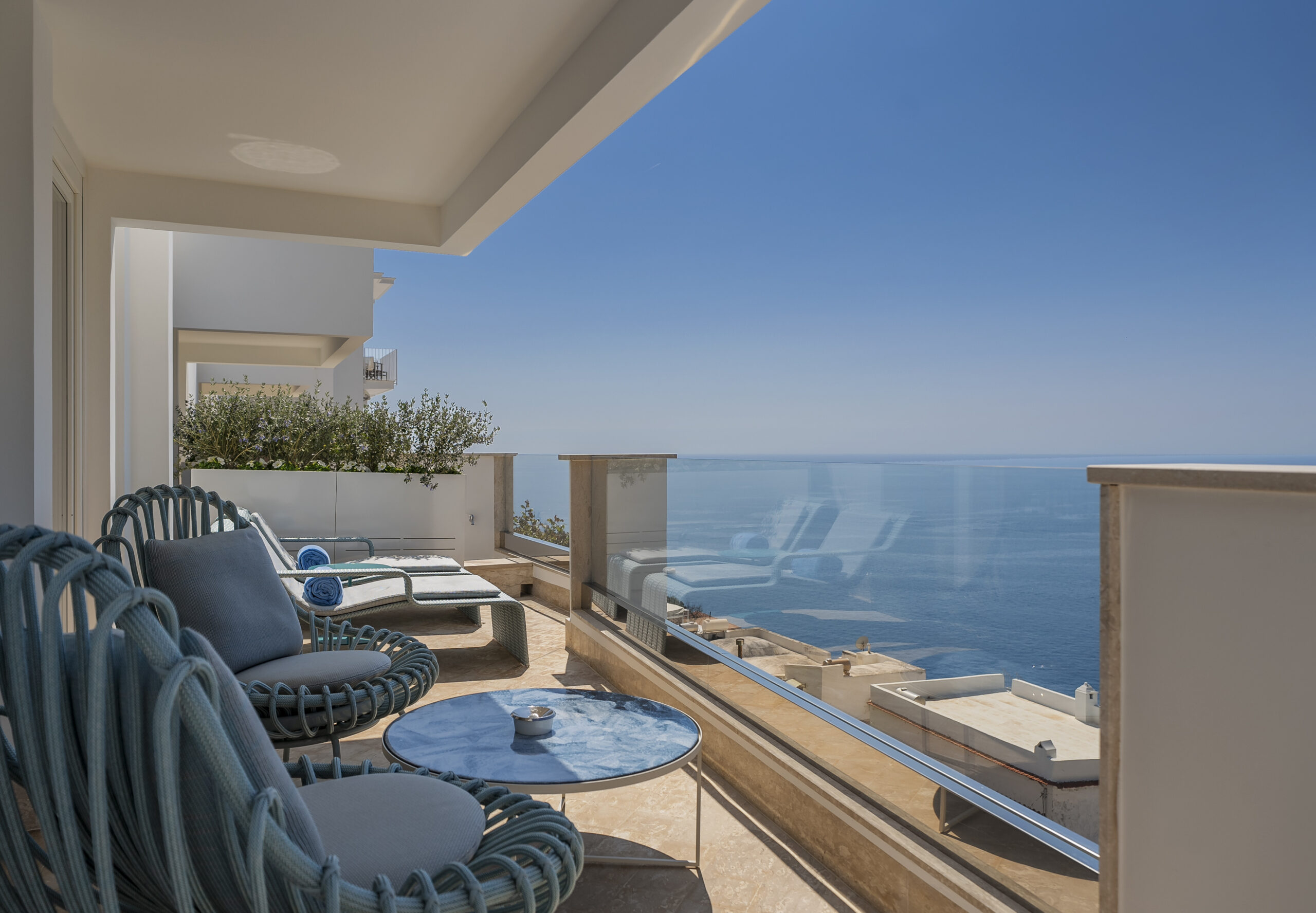 Casa Angelina balcony view of the Amalfi Coast with seating and ocean vista.