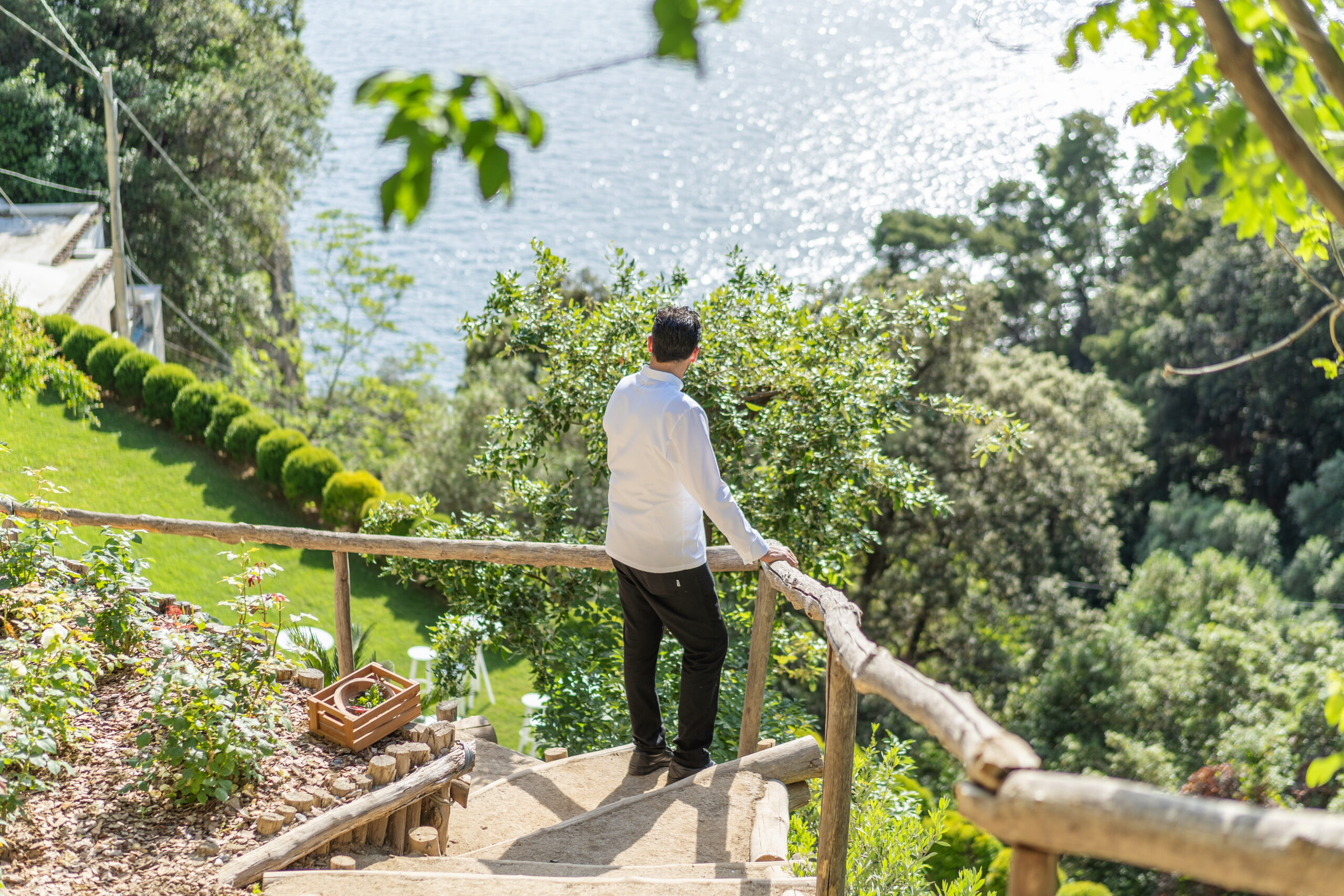 Man overlooking the Amalfi Coast from a garden at Casa Angelina.