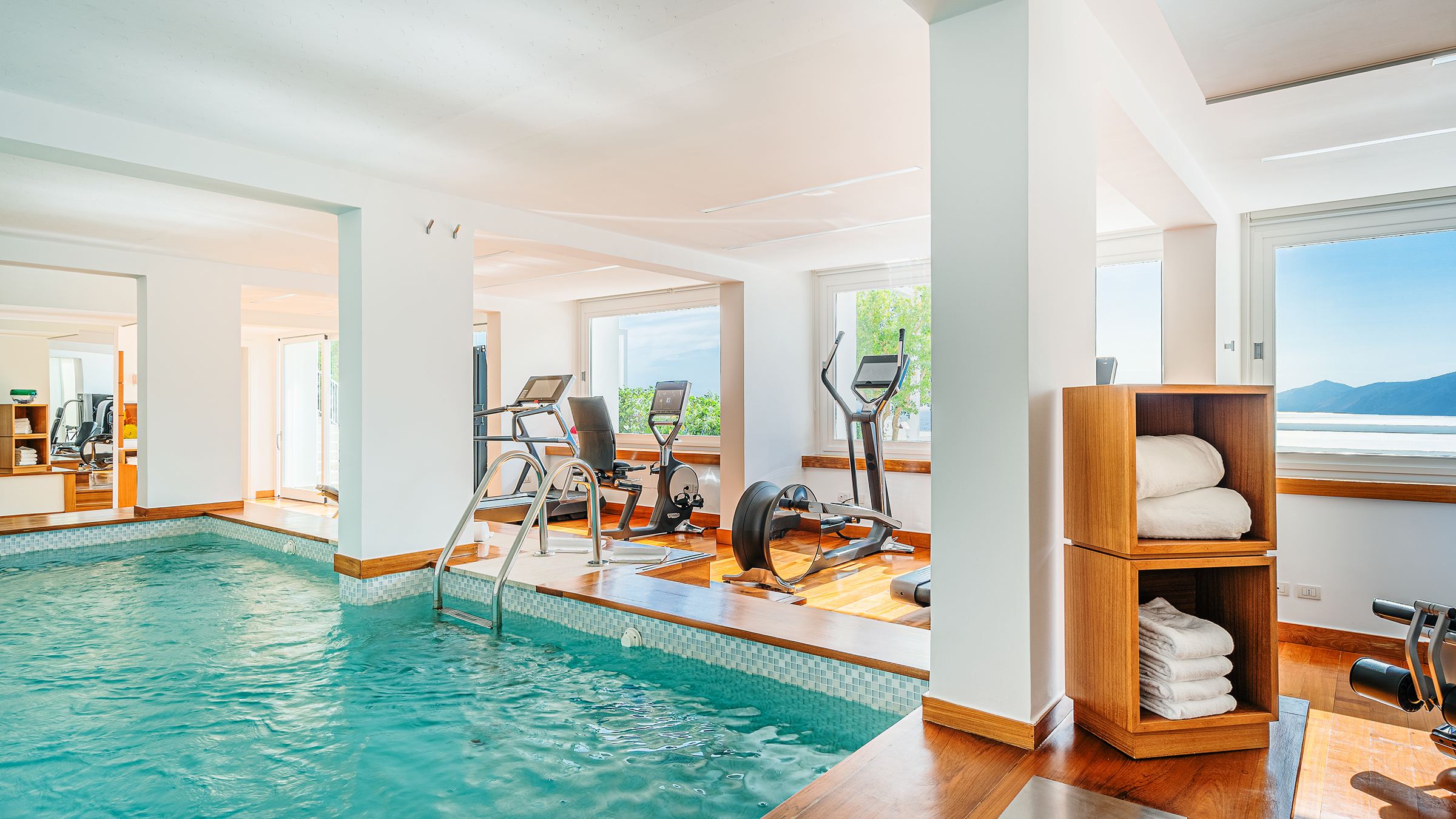 Casa Angelina gym and indoor pool on the Amalfi Coast, Italy. Fitness area with ocean view.